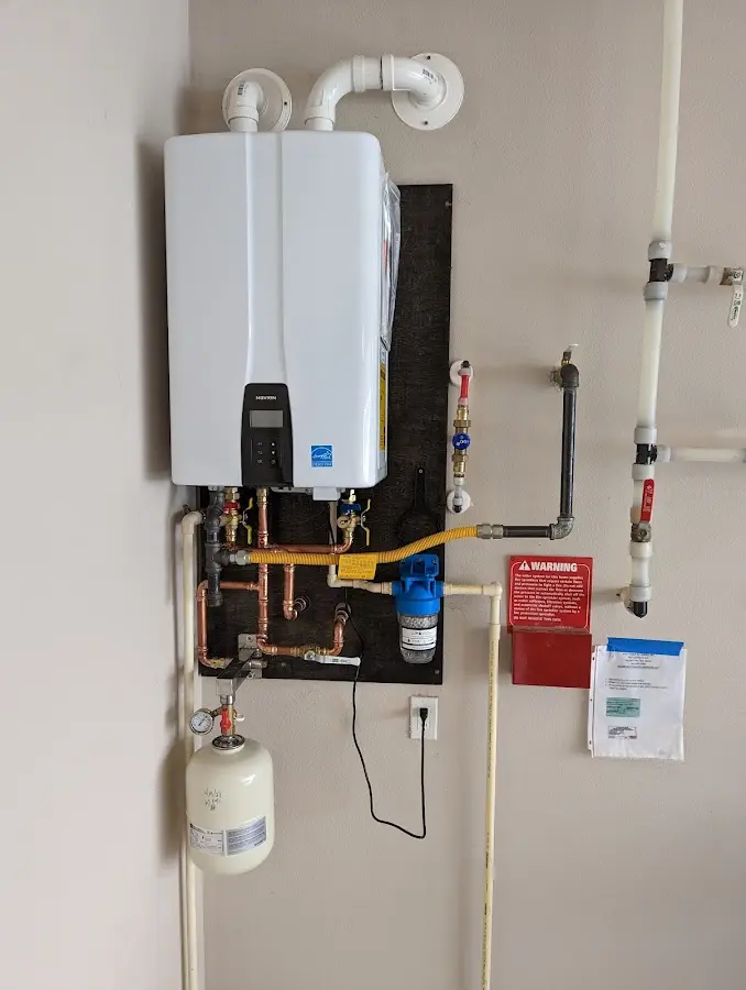 Professional plumber installing copper piping in a Windham home